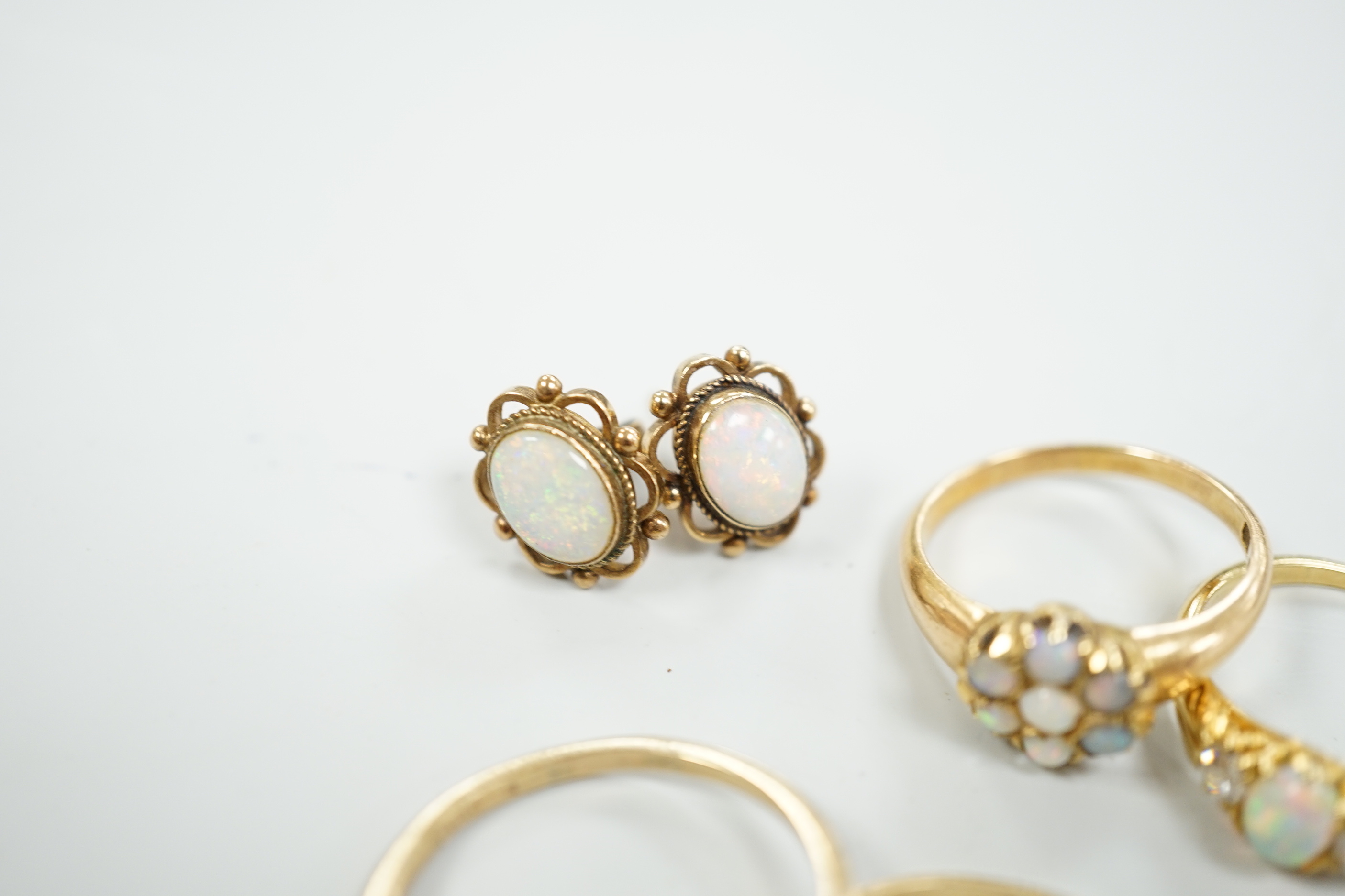 Two 18ct and white opal set rings, one with diamonds, gross 6.2 grams, a 14ct and white opal ring, a 9ct gold and white opal ring and a pair of 9ct gold and white opal earrings.